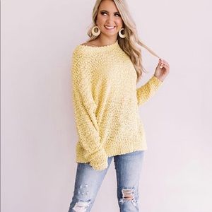 Light yellow popcorn sweater.